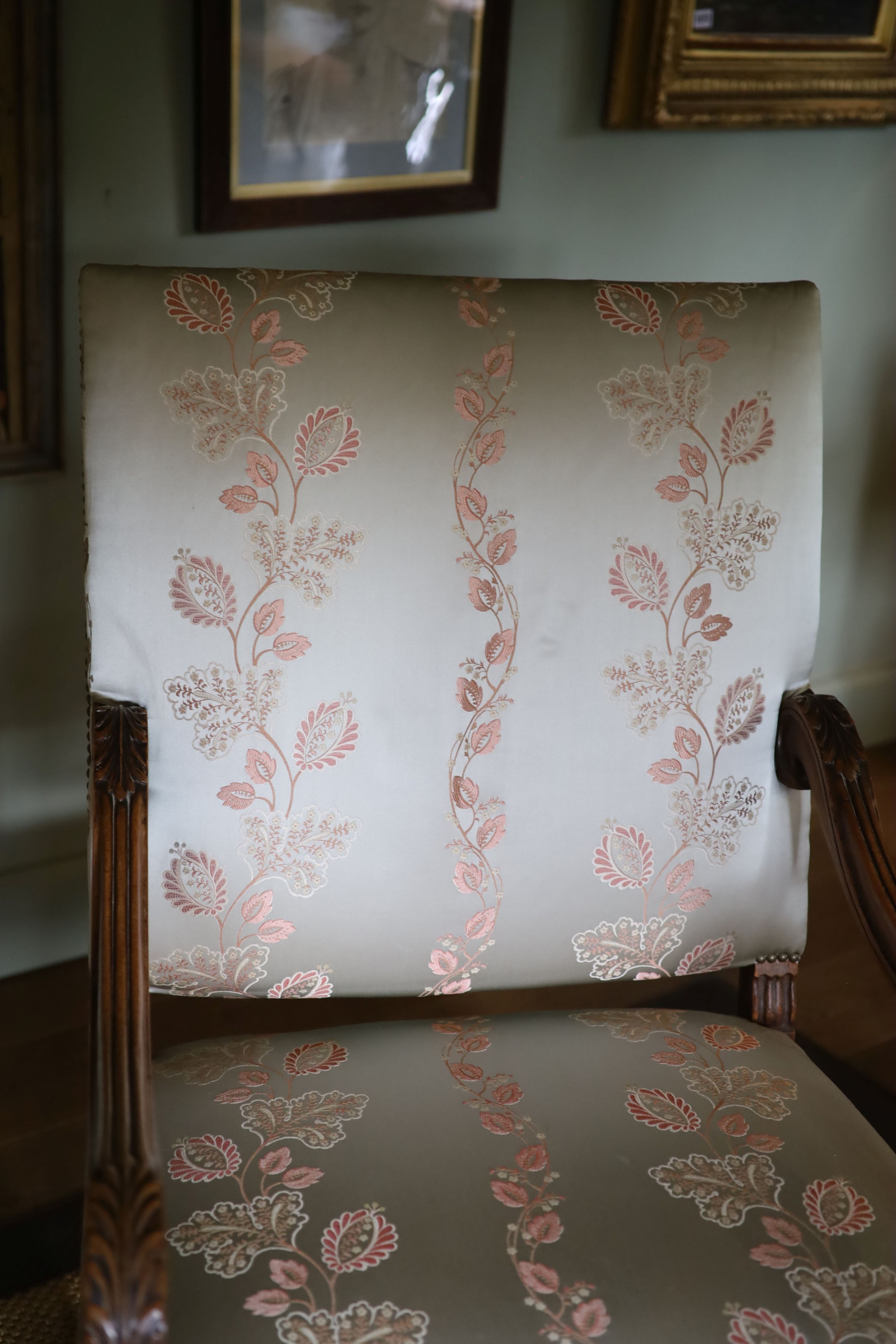 A pair of French carved walnut fauteuils, with machine embroidered Eau de Nil silk upholstery, width 66cm height 106cm